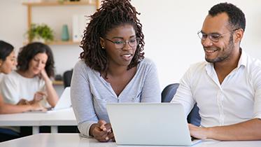 Two students looking at a computer screen